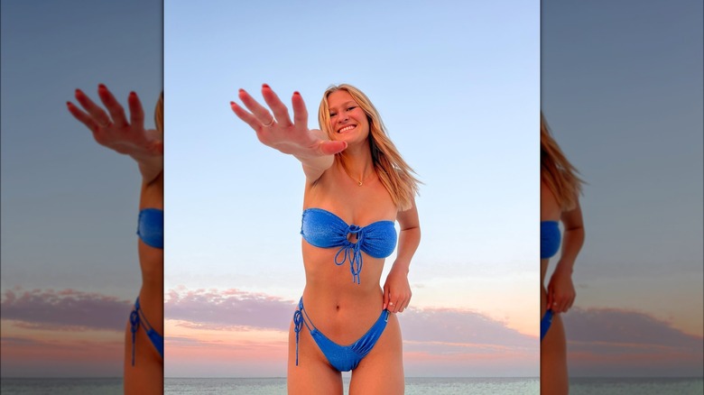 Woman wearing shimmery blue bikini in ocean