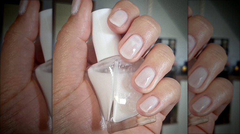 hand with milky white shimmer nails