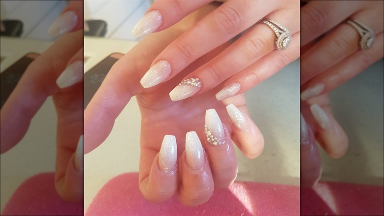 hands with white shimmer ombre nails