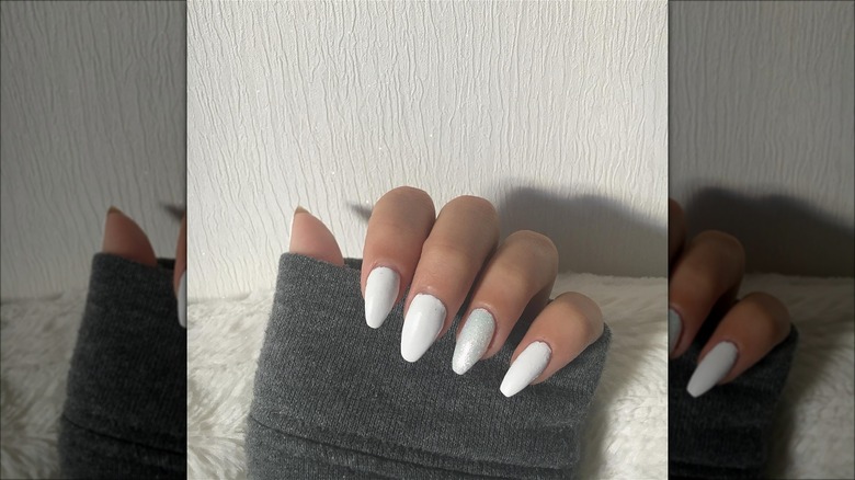 hand with white shimmer nails