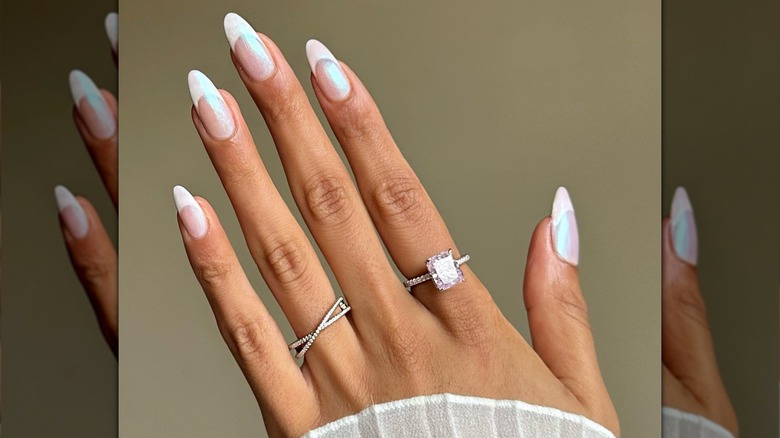 hand with white shimmer french tip nails