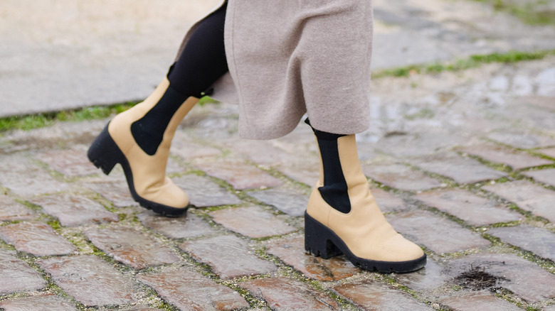 Person walking in yellow-beige chunky boots