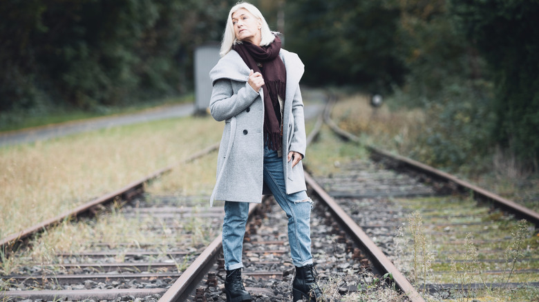 An older blond woman in chunky boots and jeans.