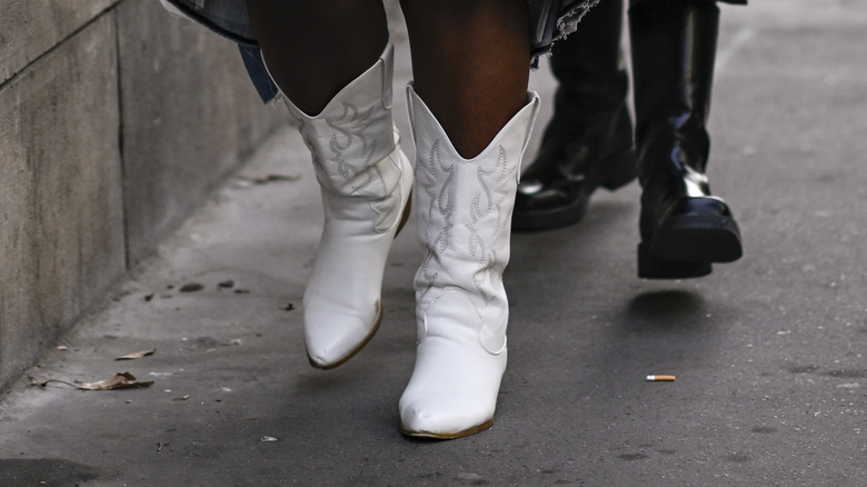 woman wearing white cowboy boots