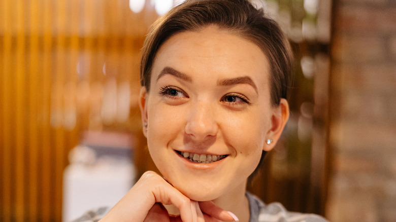 woman with pixie cut smiling