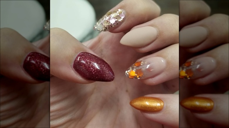 hand with short stiletto autumn nails