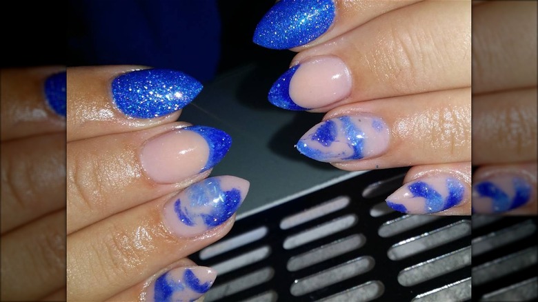 hand with blue short stiletto nails