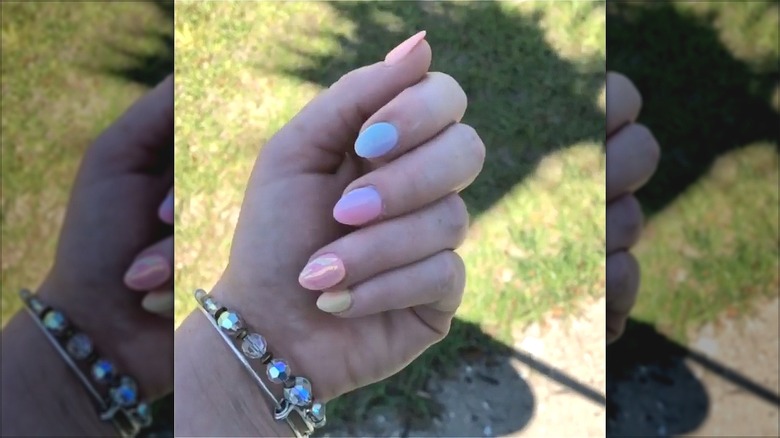 hand with multicolored pastel short stiletto nail