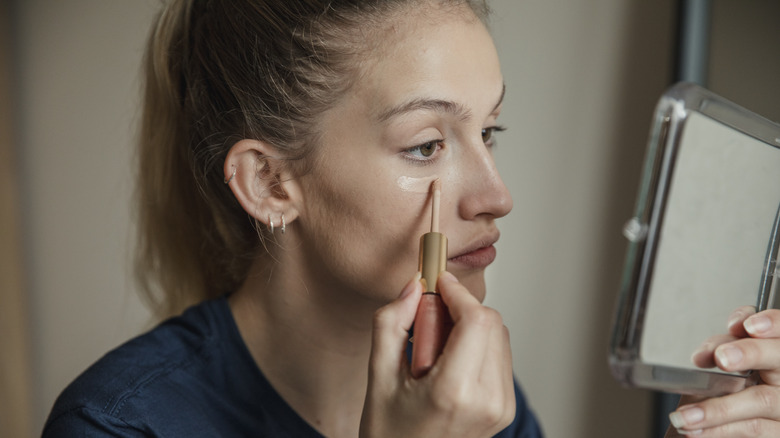 woman applying makeup