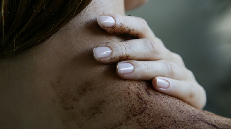 Woman exfoliating neck skin