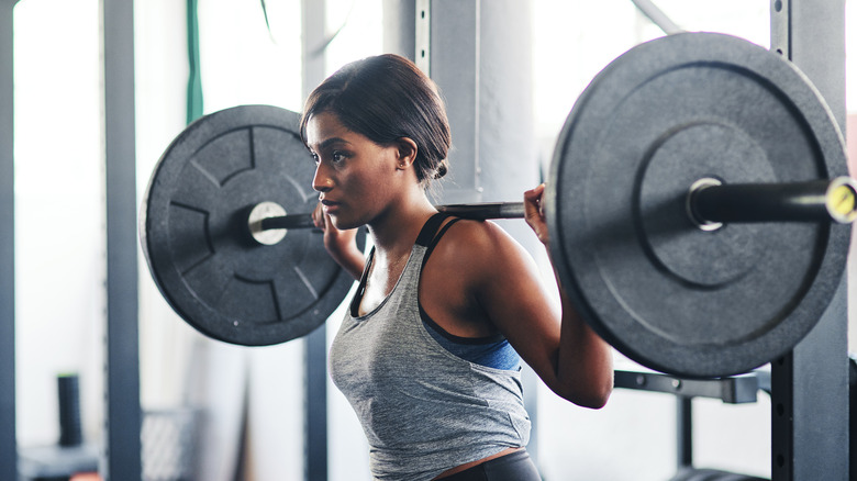 Woman lifting heavy weights