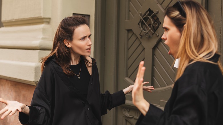 two women arguing outside