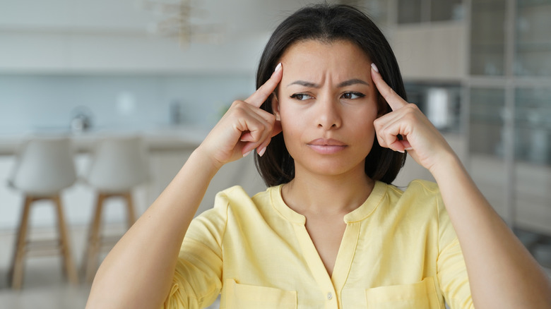 confused woman touching head