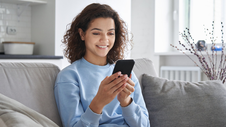 woman smiling at phone