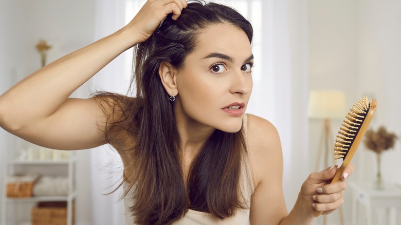 woman checking hairline