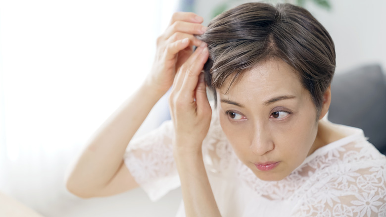 woman checking her hair