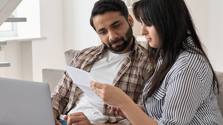 a couple looking at their bills