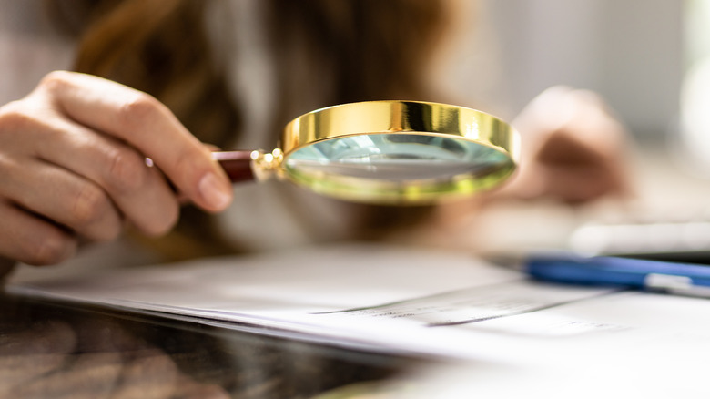 Magnifying glass held to paper