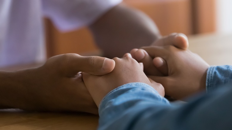 two people holding hands