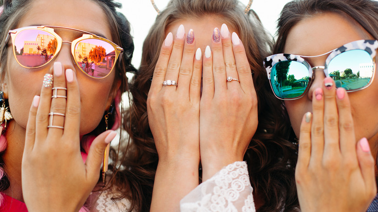 three women showing off colorful manicure