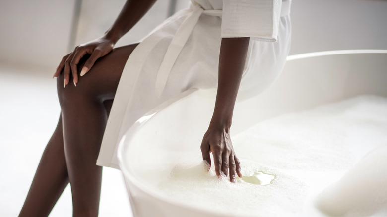 young black woman drawing a bath