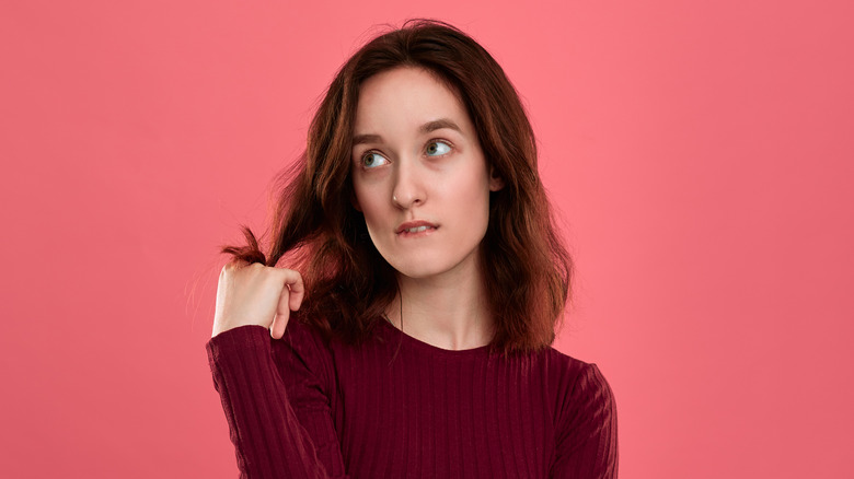 bored woman twirling hair