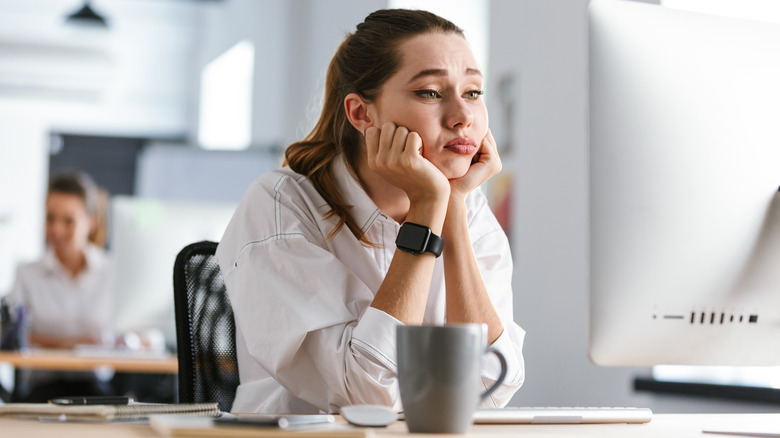 sad woman at desk