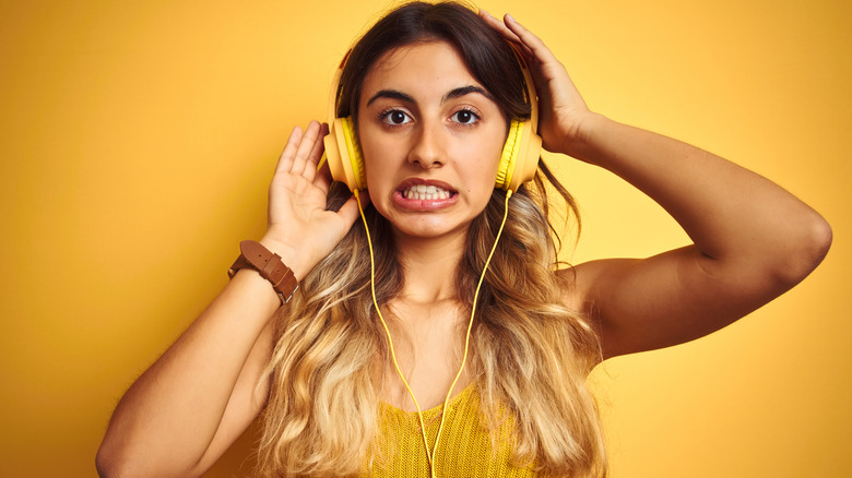 woman wearing yellow headphones 