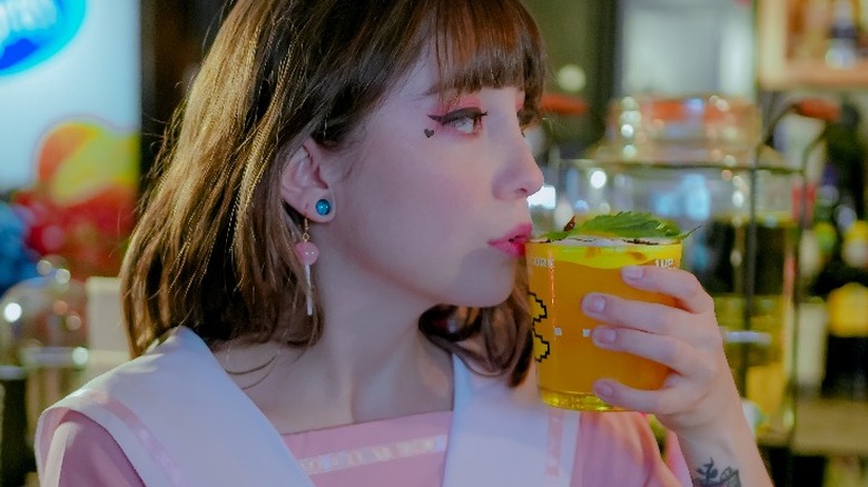 girl in pink dress drinking