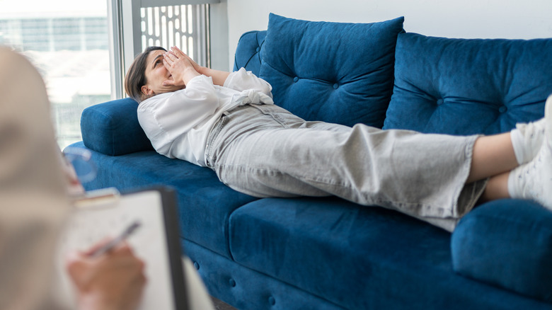 woman lying on couch