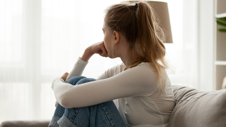 woman thinking and looking outside