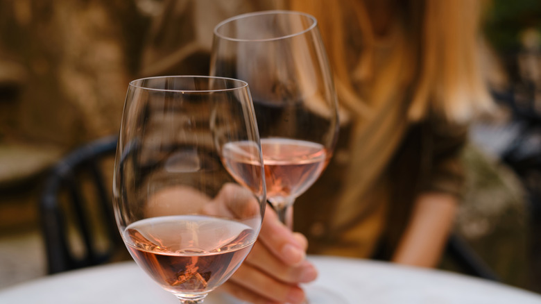 woman holding glass of wine