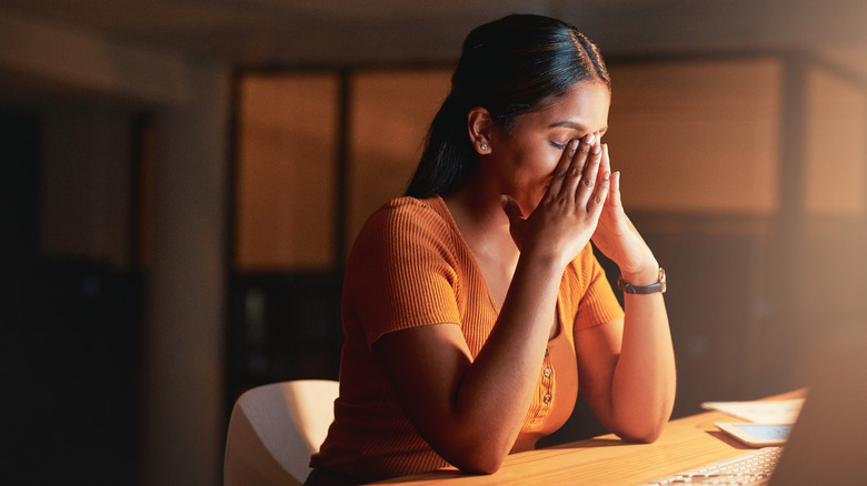 woman with hands to her face