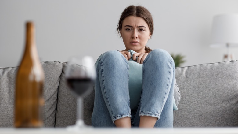 woman staring at alcohol