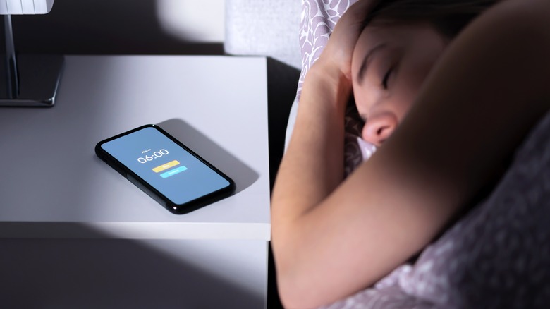 woman sleeping through alarm