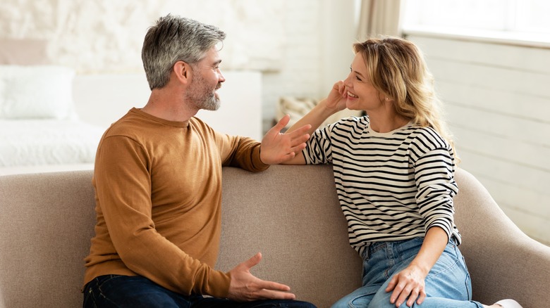 Couple talking on a couch 