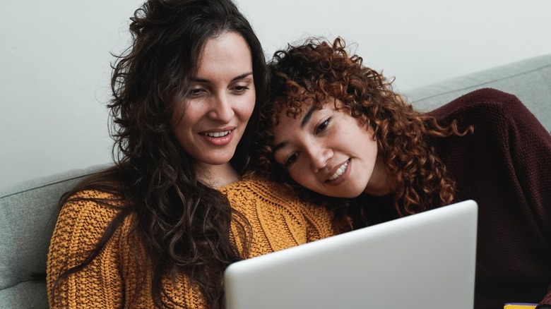 happy lesbian couple with laptop