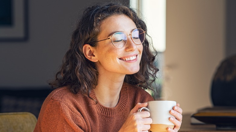 smiling woman with eyes closed