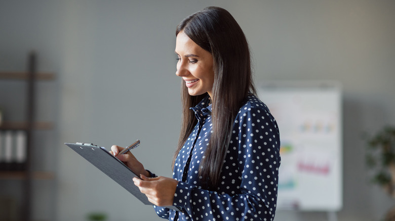 smiling woman with checklist