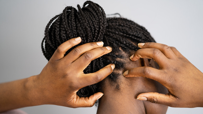 woman touching her scalp