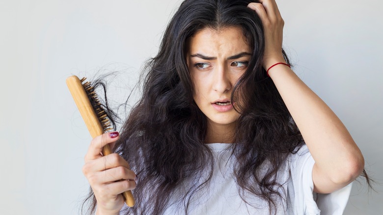 woman experiencing hair shedding