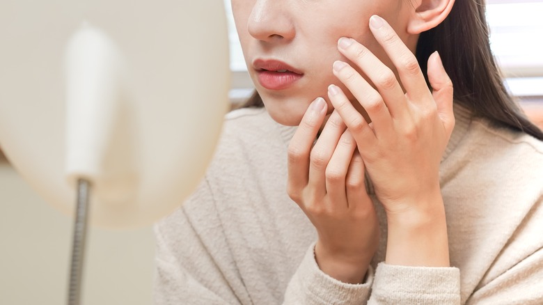 Woman looking at complexion