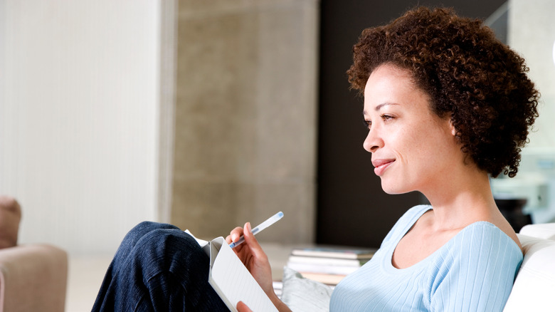 Relaxed woman journaling at home