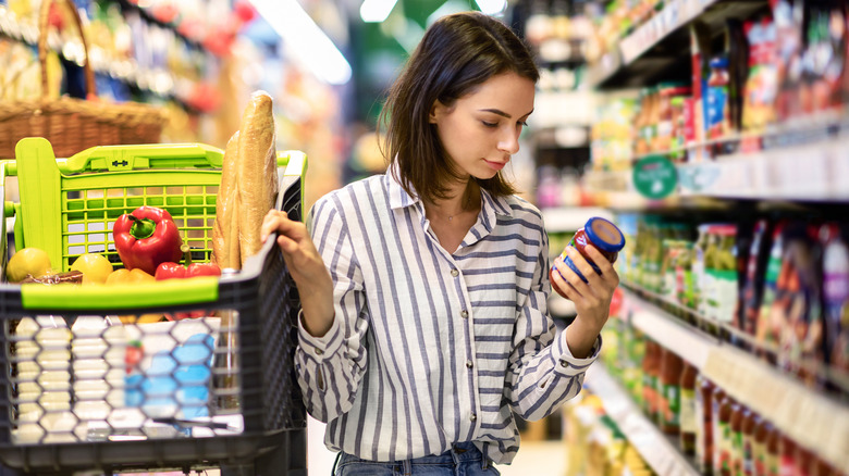 woman reading nutritional label