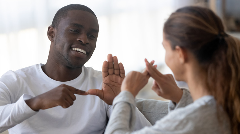 couple speaking sign language smiling