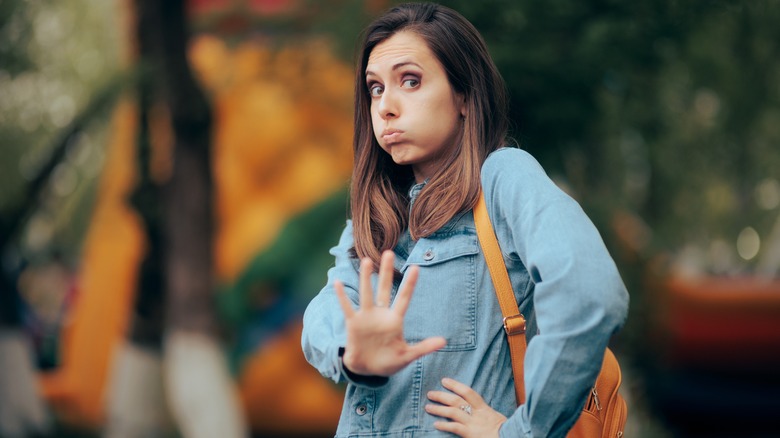 Woman holding out a hand 