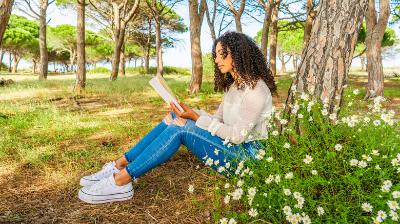 Woman reading a book outside