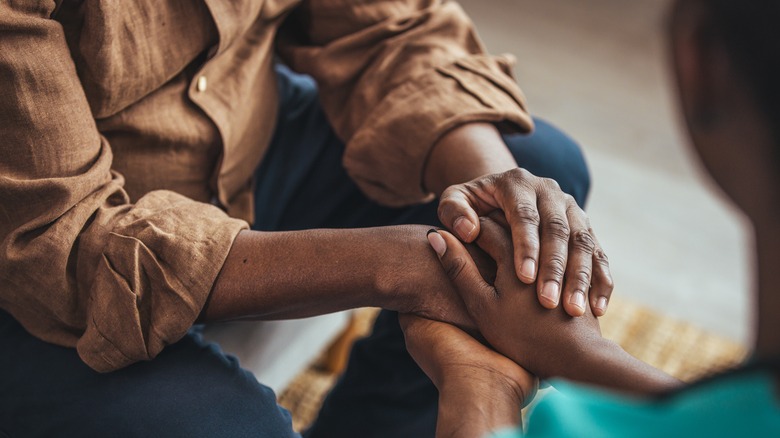 man and woman holding hands