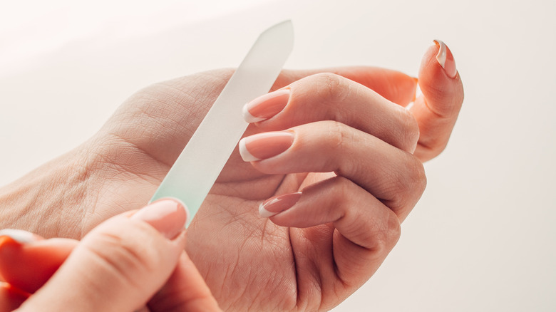 woman using glass nail file