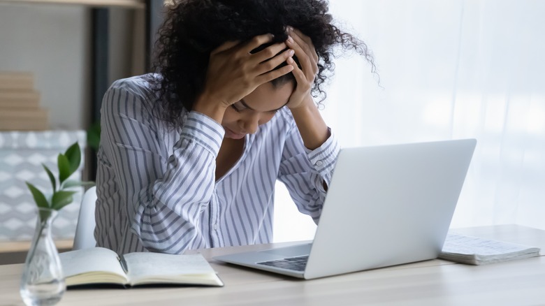 Woman feeling upset at her computer